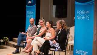 Panel group talking and sitting at forum