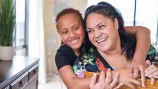 mother daughter laughing hugging