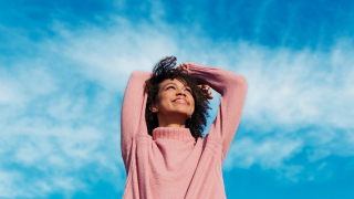 Girl in pink jumping with joy