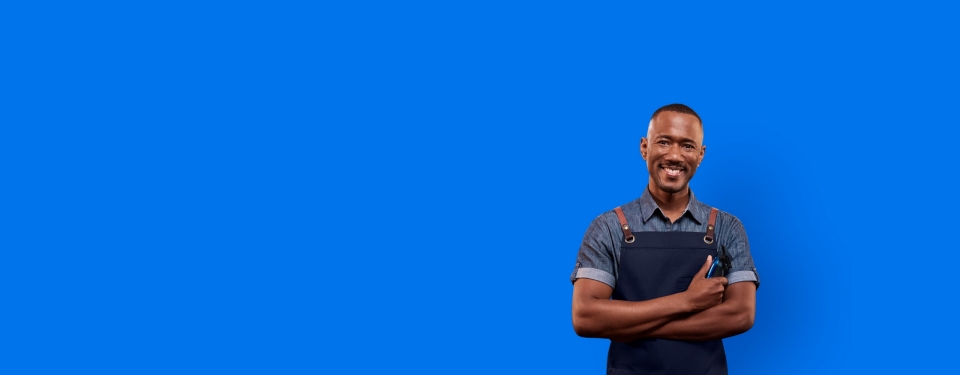 young male barber business owner smiling