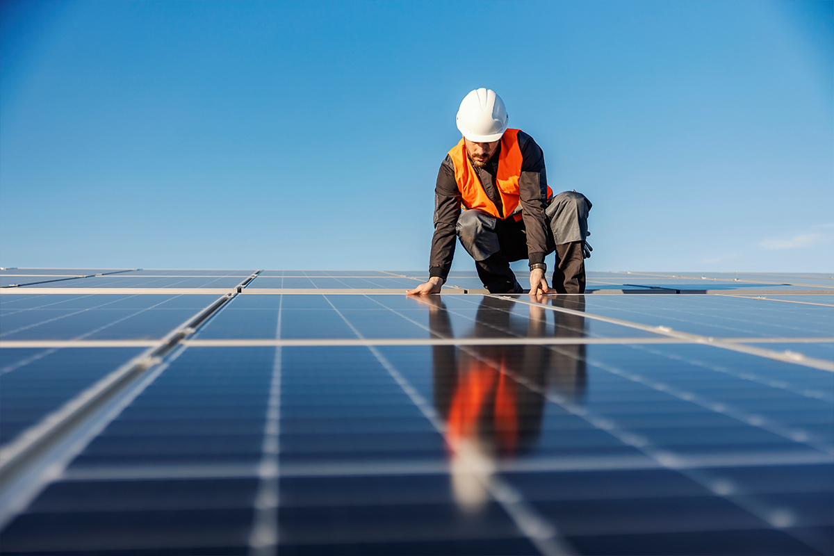 man fixing solar panels