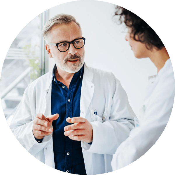 Doctor in coat talking to colleague