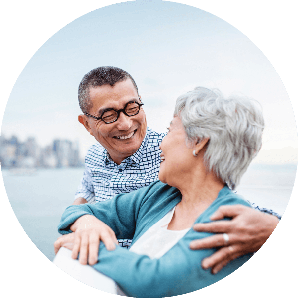 Happy elderly couple smiling at each other